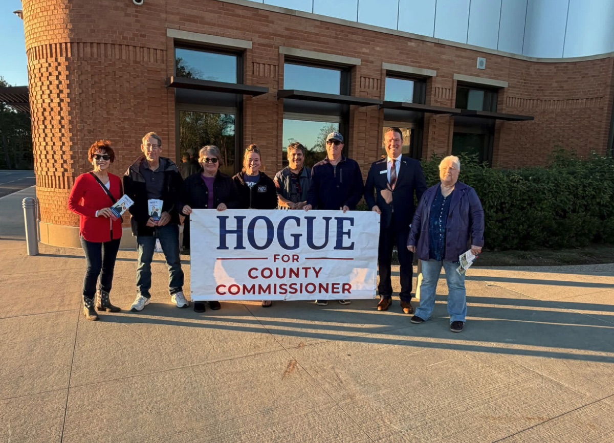 Volunteers holding a Hogue for County Commissioner banner at a standout